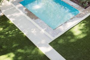 an overhead view of a swimming pool with grass at Minty Stay - Palmera in Seville