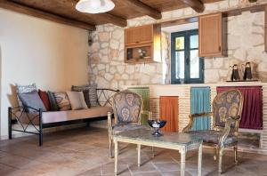 a living room with a couch and chairs and a table at Diamond Suites in Vasilikos
