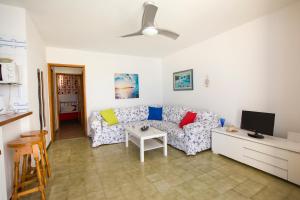 a living room with a couch and a tv at Costa Agaete - Puerto de las Nieves in Puerto de las Nieves
