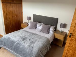 a bedroom with a large bed with two night stands at Ardconnel Bed and Breakfast in Kirkwall