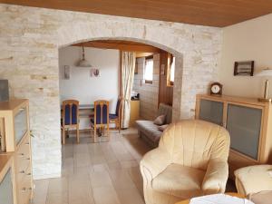 a living room with a stone wall at Haus Krick in Alpirsbach