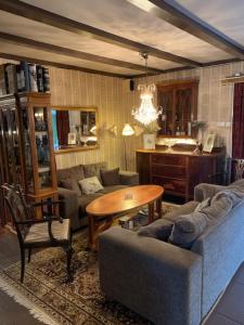 a living room with a couch and a table at Furuliden Country Inn in Vittsjö