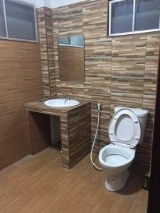 a bathroom with a toilet and a sink at Mitaree 2 in Mae Sariang