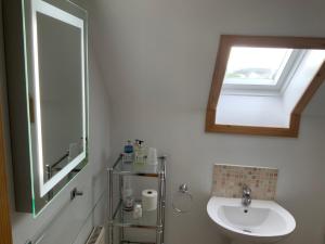 a bathroom with a sink and a toilet and a mirror at Ardconnel Bed and Breakfast in Kirkwall
