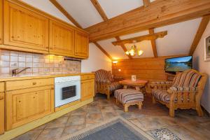 a kitchen with wooden cabinets and a table and chairs at Ferienhaus Alpenzauber in Krün