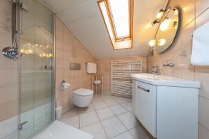 a bathroom with a toilet and a shower and a sink at Ferienhaus Alpenzauber in Krün +39 photos