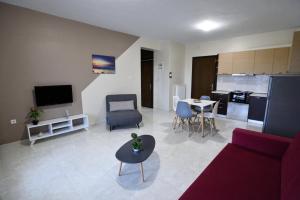 a living room with a couch and a table at San Giorgio Luxury Apartments in Ierissos