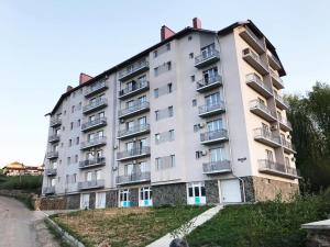 a large apartment building on the side of a road at Сонячне Закарпаття in Polyana