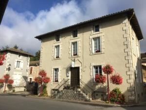 a large white building with flowers in front of it at La Belle Vienne in Exideuil