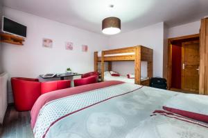 a bedroom with a large bed and red chairs at L auberge du basilico in Aime