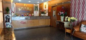 a lobby of a restaurant with a counter with flowers at Fu Men Hotel in Pingtung City