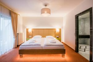 a bedroom with a large bed and a large window at Eden au Lac in Echternach