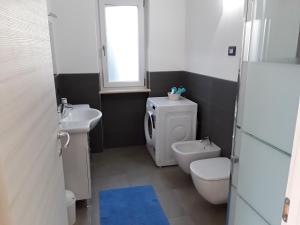 a small bathroom with a toilet and a sink at Casa Punta Veleno in Brenzone sul Garda +43 photos