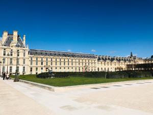 a large building with a park in front of it at 21a Maréchal FOCH Avenue Paris CHAMPS-ELYSÉES in Paris