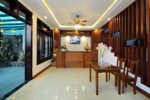 a lobby of a hotel with a table and chairs at Threeway Riverside Villa in Hoi An