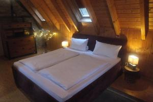 a bedroom with a large bed with white sheets and pillows at Rheinufer-Lodge in Leverkusen-Hitdorf-mit Blick auf den Rhein - Zentral an der A1 und der 59 in Leverkusen