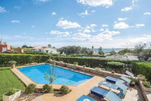 an overhead view of a swimming pool with chairs at Villa Betonia in Punta Prima