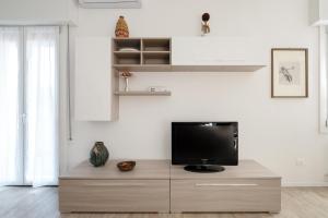 a tv sitting on top of a dresser in a room at L'appartamento del portico Mazzini in Bologna