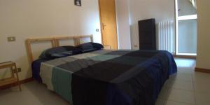 a bedroom with a bed with a colorful blanket on it at Via Brecce Bianche, 70 in Ancona