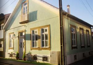 a yellow and white house with a balcony at Watermark Surf House in Espinho