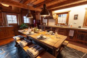a large kitchen with a wooden table and benches at Chez « Adèle » in Ayent