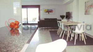 a kitchen and living room with a table and chairs at Astonishing beach and pool house in Mazarrón