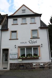 a white building with a sign that reads holis cities at Pension Haus Thies in Cochem