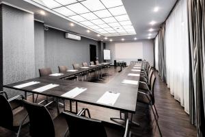 a conference room with long tables and chairs at Rija VEF Hotel with FREE Parking in Rīga