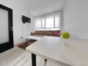 a living room with a white table and a couch at Libero in Sarajevo