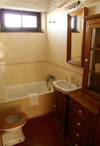 a bathroom with a toilet and a tub and a sink at 4Sea House in Porto Covo +54 photos