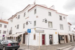 a white building on the side of a street at Casa dos Mouros in Évora