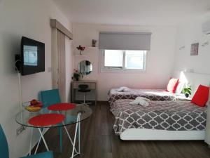 a small room with two beds and a table at Chicos Studios in Ayia Napa