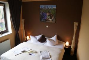 a hotel room with a bed with white sheets at Landhotel Berggaststätte Bickenriede in Anrode +48 photos