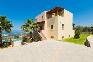 a villa with a view of the ocean at Maroulas Villas Ioanna & Stavros, stunning views, By ThinkVilla in Maroulás