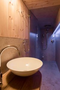 a bathroom with a white sink and a shower at Chalet Berghaus Bartholomäberg in Bartholomäberg