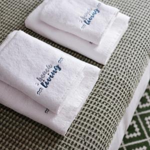 two white towels with the words happy birthday on them at BeachLiving Cortegaça in Cortegaça