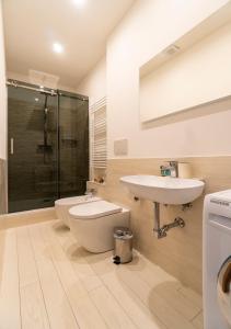 a bathroom with a sink and a toilet and a shower at Residence Cairoli 9 by Studio Vita in Bologna