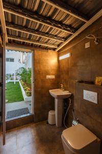 a bathroom with a toilet and a sink at Woke Indiranagar in Bangalore
