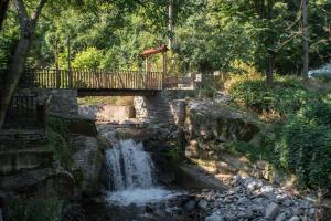 a bridge over a creek with a waterfall at комплекс ВОДОПАДА in Plovdiv