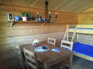 a dining room with a table and a bunk bed at Cabin on Husky Farm in Strömsund