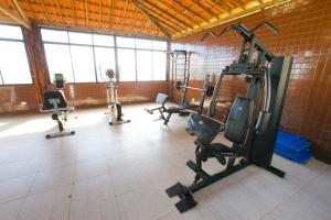 a gym with several exercise equipment in a room at Hotel Canarius D'Gaibu in Cabo de Santo Agostinho