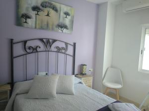 une chambre avec un grand lit avec des draps blancs dans l'établissement Casa Comendador, à Retuerta de Bullaque