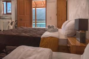 a hotel room with two beds and a television at Amazing view apartment in Plataria