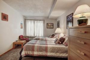 a bedroom with a bed and a dresser and a room at 2062 The Pines Condo in Keystone +21 photos