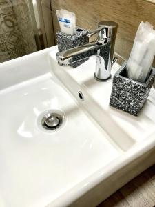 a white bathroom sink with a silver faucet at Casa Annamaria in Naples +33 photos