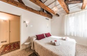 a bedroom with a bed with two towels on it at Apartment Cà Brunilda-luxury penthouse with terrace in Venice
