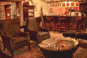 a bar with chairs and a dog laying on a table at Joshua Creek Ranch in Boerne