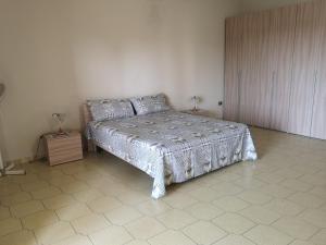 a bedroom with a bed in a room at Holiday House in Taviano