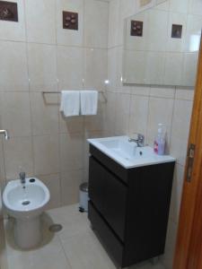 a bathroom with a sink and a toilet at Dona Matilde in Ponta Delgada