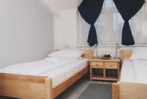 Ένα ή περισσότερα κρεβάτια σε δωμάτιο στο Bloom Inn